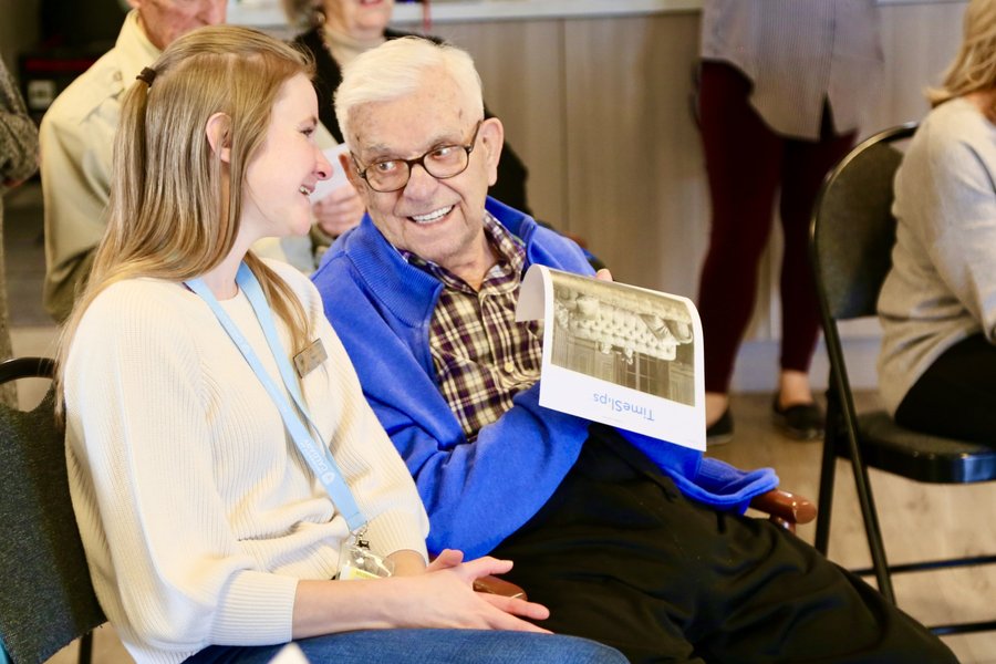 a senior sitting and talking with a volunteer