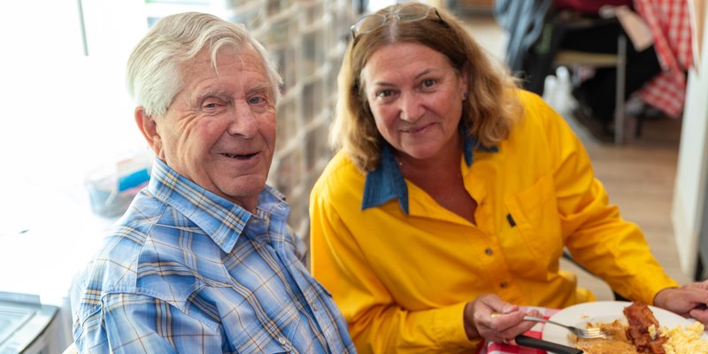 A senior couple smiling at a breakfast table