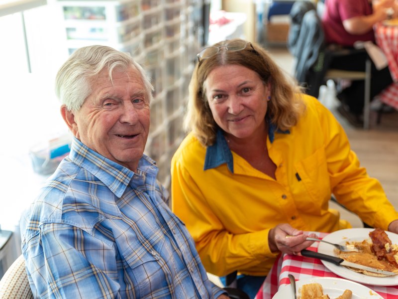 A senior couple smiling at a breakfast table