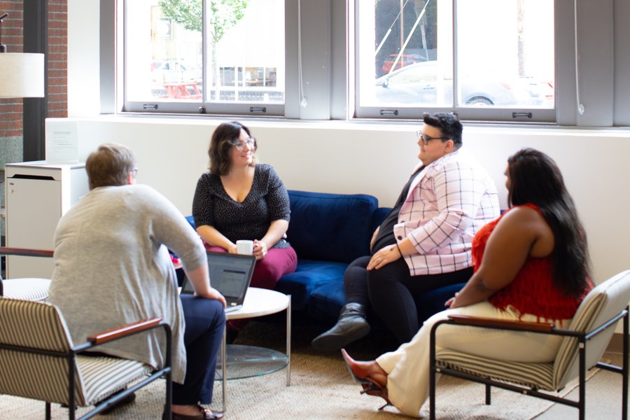 a group of people having a conversation while sitting in a circle