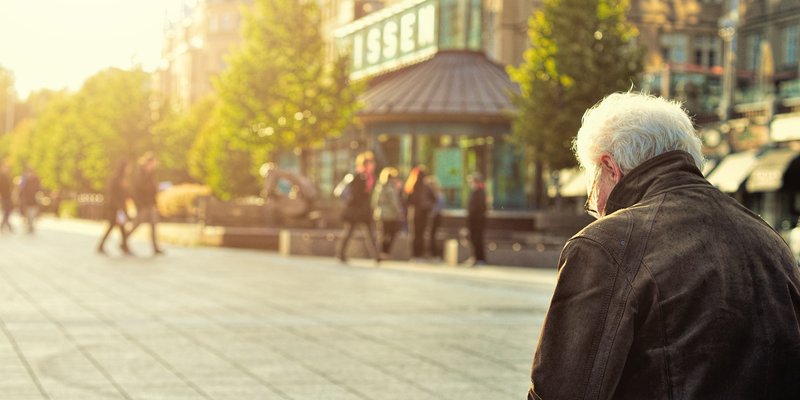 a senior sitting alone on a bench