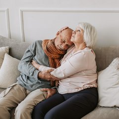 senior couple embracing on a couch