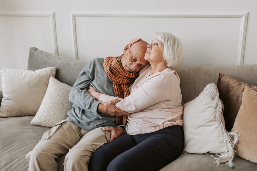 senior couple embracing on a couch